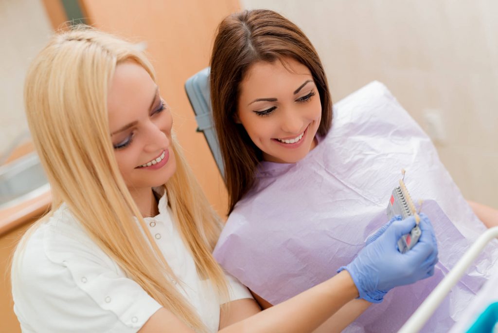 Dentist and patient looking at shade options for veneers in Simpsonville, SC