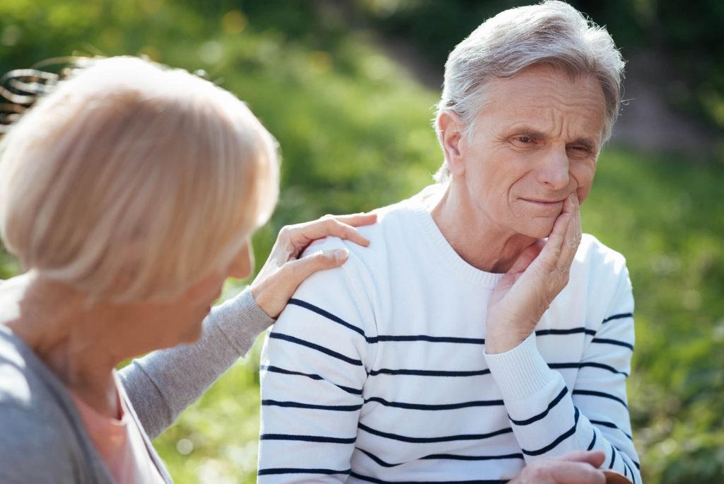 old man with tooth pain and needs an emergency dentist in Simpsonville, SC
