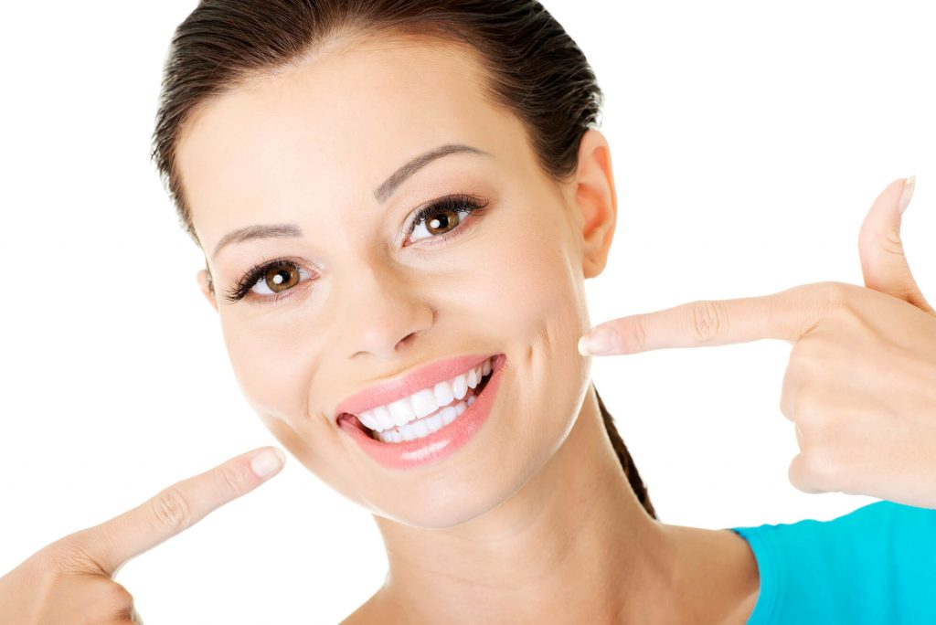 female patient showing her beautiful teeth after seeing a cosmetic dentist in Simpsonville, SC