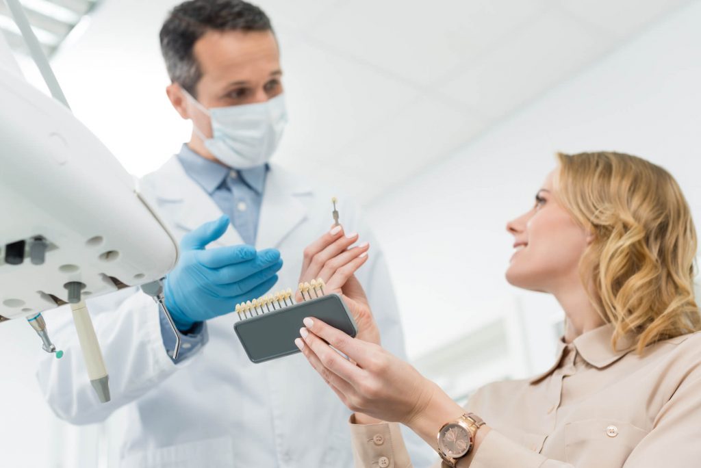 cosmetic dentist in Simpsonville, SC, talking to his patient for her dental implants