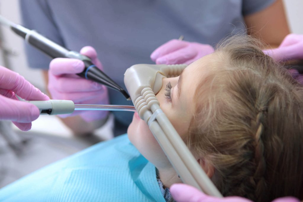 an expert in sedation dentistry in Greenville SC works on a child's teeth
