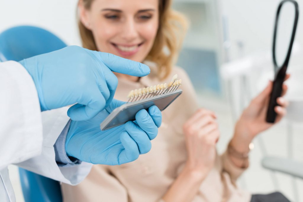 dentist showing patient her options for her dental implants in Greenville, SC
