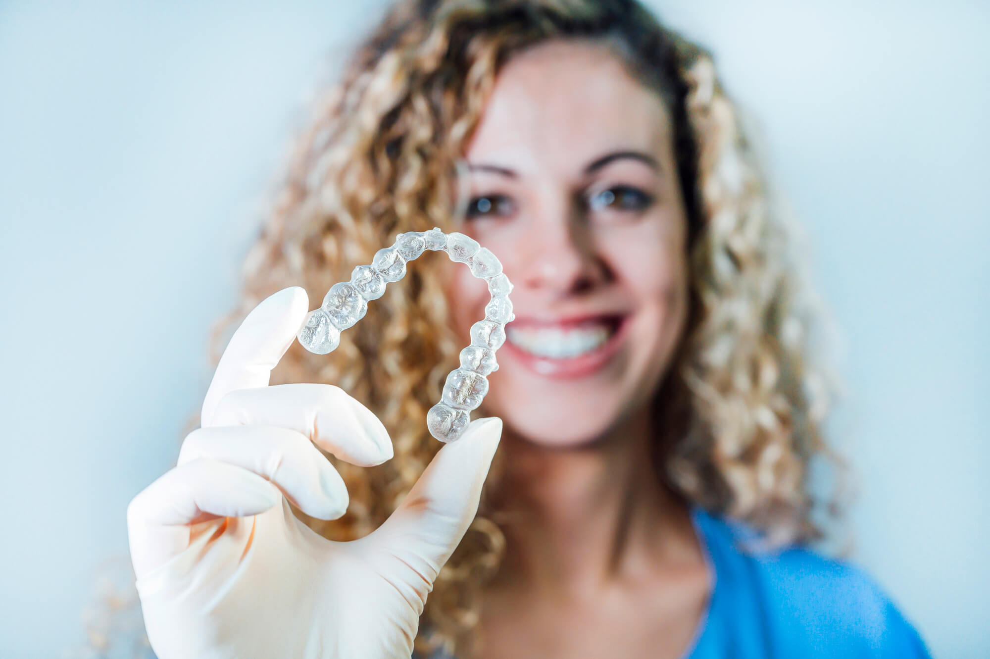Dentist holding an Invisalign Simpsonville SC