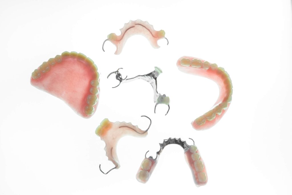 complete and partial dentures in Greenville SC over white background