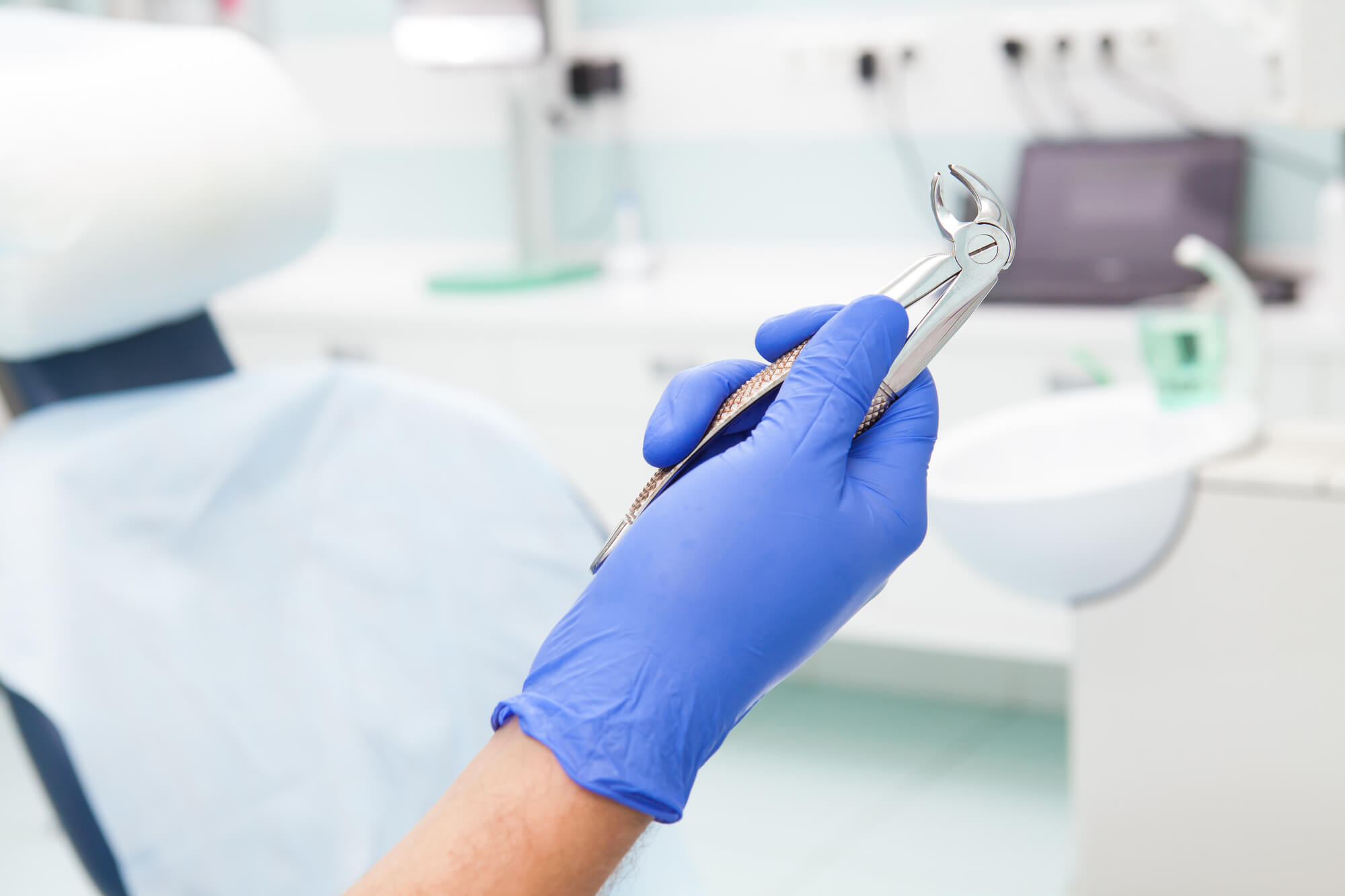dentist holding dental tool used for tooth extractions in Greenville SC