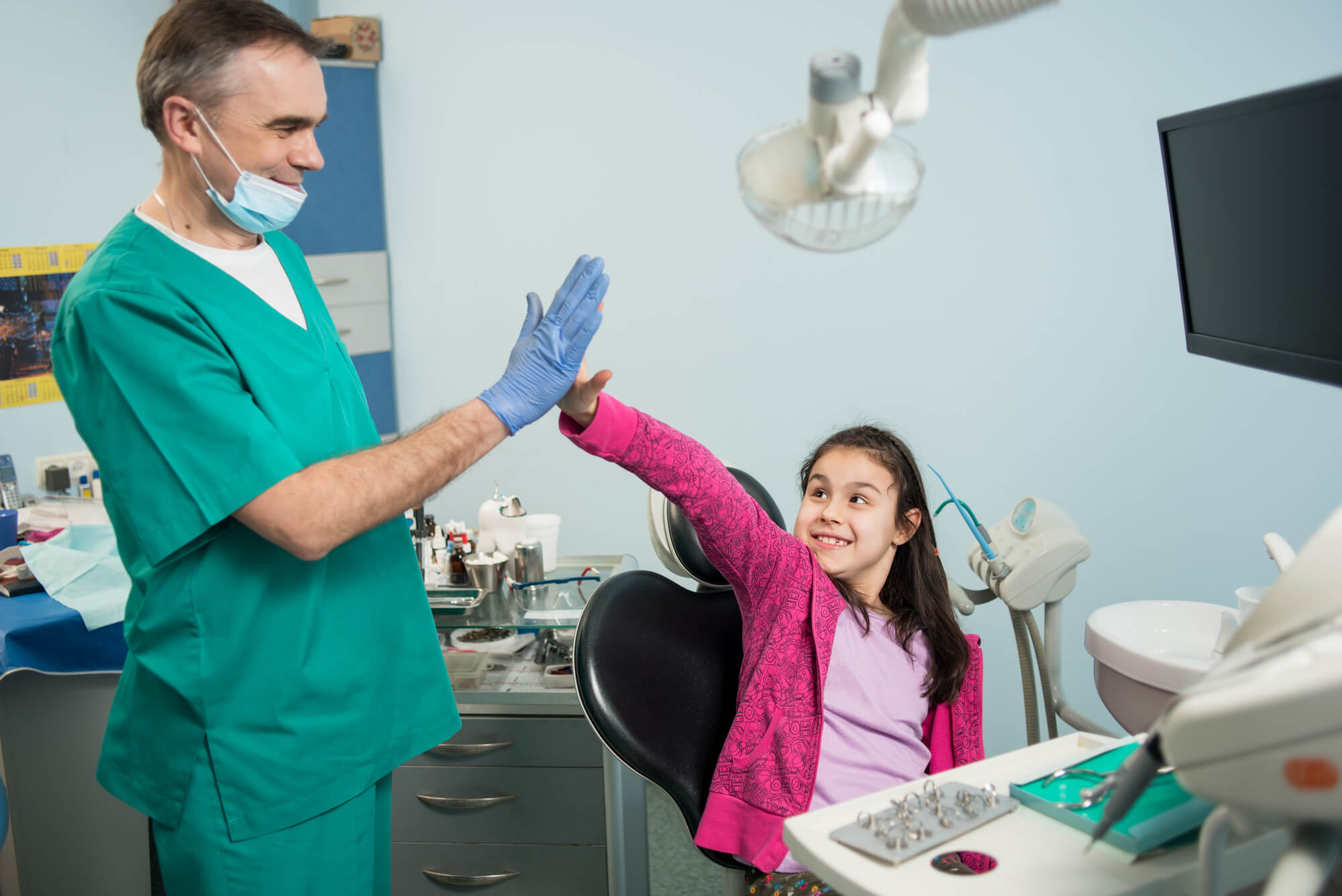 a emergency dentist Simpsonville SC giving a high five to kid