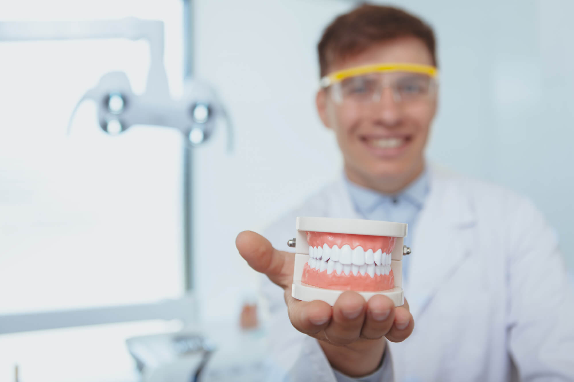 dentist holding a dentures Simpsonville SC model